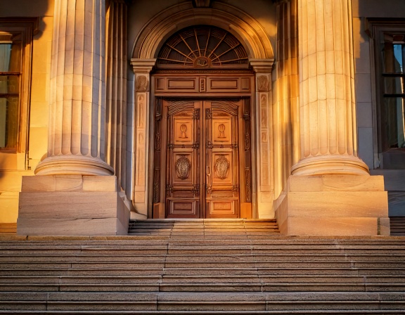 Courthouse doors open onto evening light